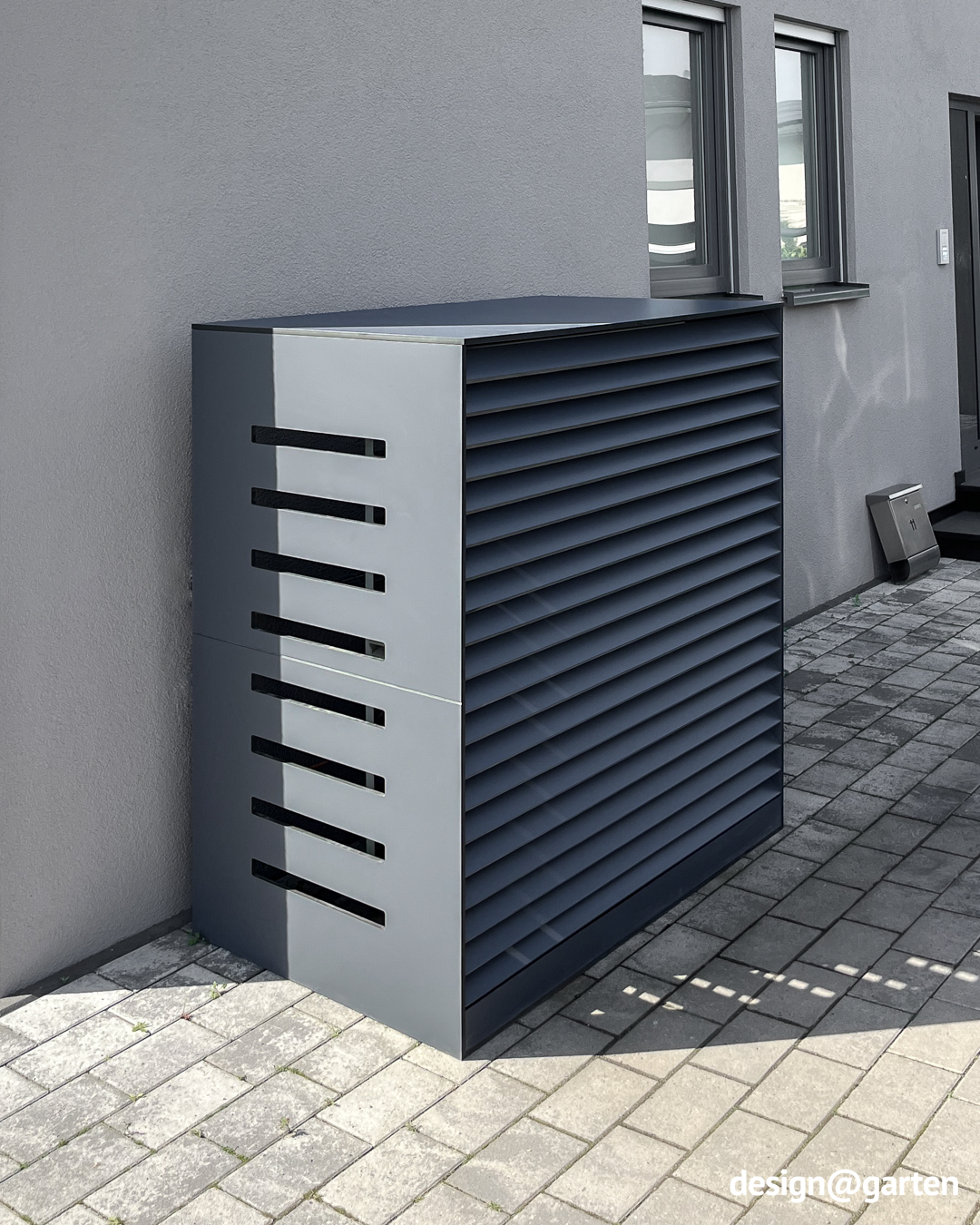 Grey cladding for heat pump with ventilation slots