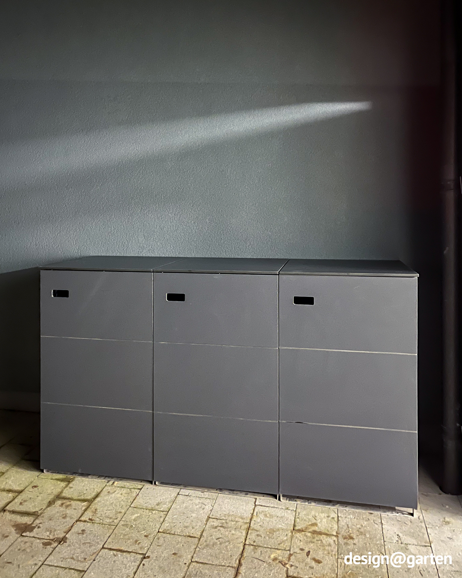 Straight-lined 3-bin waste bin enclosure as a space-saving storage option in the garage entrance