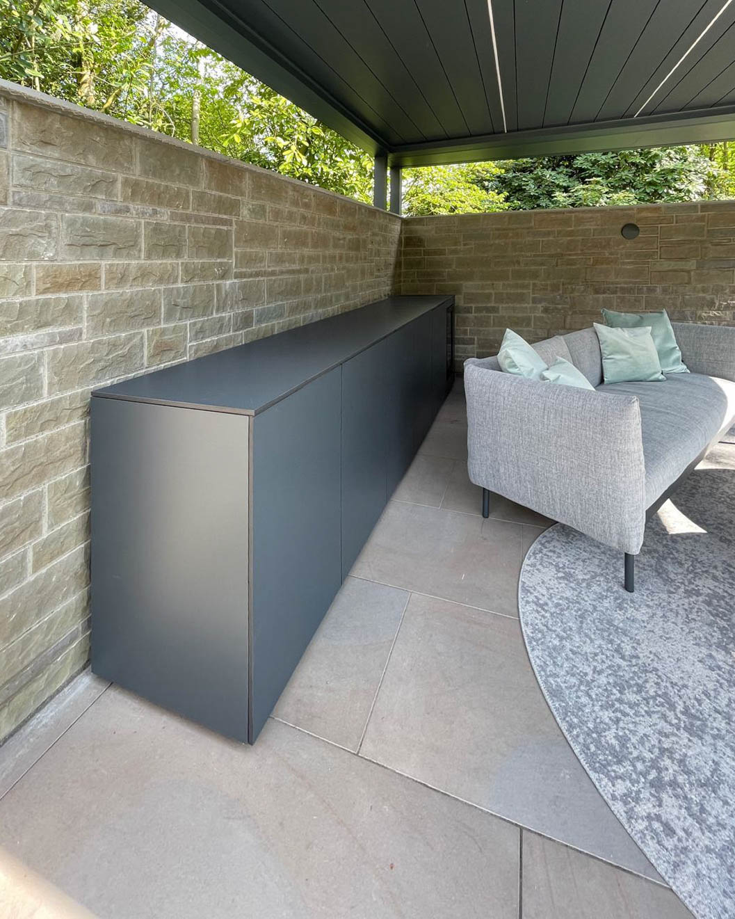 Long outdoor kitchen with built-in fridge