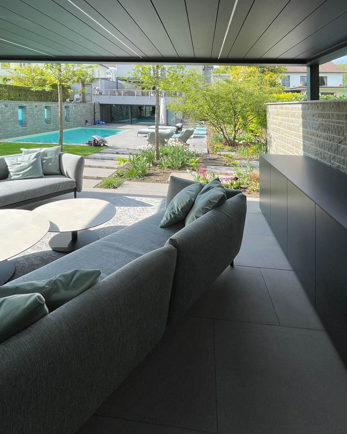 Long outdoor kitchen with built-in fridge